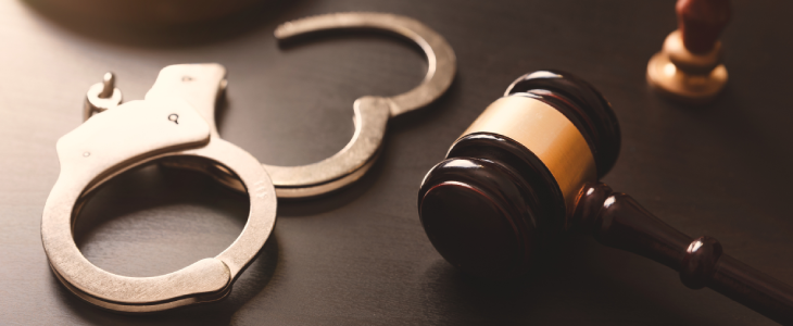 Handcuffs next to a mallet to represent criminal justice