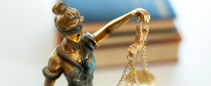Criminal justice represented by statue holding scale