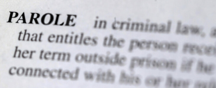 close up photo of the word parole in the dictionary