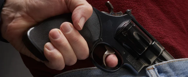 Close up of man holding a revolver